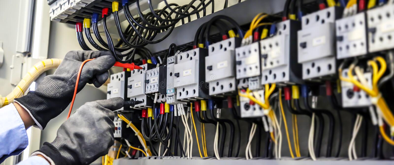 close-up-hand-electrical-engineering-using-measuring-equipment-tool-to-checking-electricity-circuit-breaker-cable-wiring-214523687